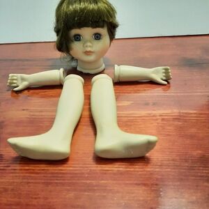 Adorable Doll head  with Green Eyes and Brown Hair. Arms and legs included .